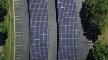 Daytime aerial view of solar car ports in a parking lot at the University of Minnesota Twin Cities campus