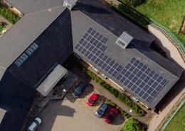 Daytime aerial view of a rooftop solar installation on a building managed by Merthyr Tdyfil Town Council