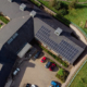 Daytime aerial view of a rooftop solar installation on a building managed by Merthyr Tdyfil Town Council