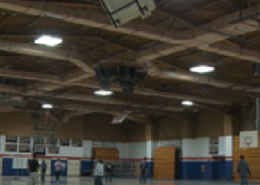 Interior view of a gymnasium at Revere Public Schools showing LED light fixtures