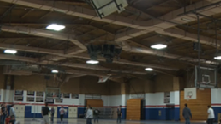 Interior view of a gymnasium at Revere Public Schools showing LED light fixtures