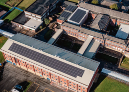 Daytime aerial view of buildings at Beckfoot Heaton showing solar panels on the roofs