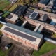 Daytime aerial view of buildings at Beckfoot Heaton showing solar panels on the roofs