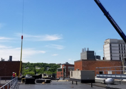 Daytime view of construction work on the roof of Massachusetts College of Art and Design