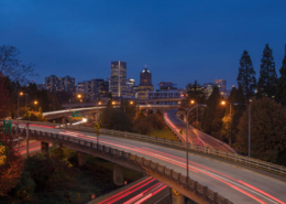 Evening view of the Portland, Oregon skyline with highways in the foreground