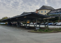 Daytime view from the parking lot of a new solar carport in Pembrokeshire County, Wales.