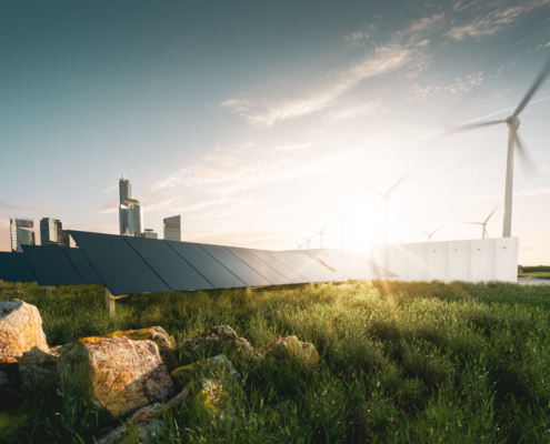 Concept image showing a futuristic skyline behind solar panels and wind turbines in a stony field