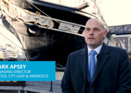 Screen capture showing Bristol City Leap and Ameresco Managing Director Mark Apsey speaking in front of a historic ship in Bristol