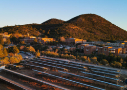 Daytime view of solar car ports at St. John's College with mountains in the background