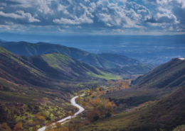 Daytime view of a river in San Bernardino California with hills on either side