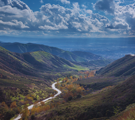 Daytime view of a river in San Bernardino California with hills on either side