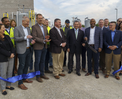 Daytime view of a ribbon cutting for the Benson Valley landfill gas to energy plant