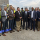 Daytime view of a ribbon cutting for the Benson Valley landfill gas to energy plant