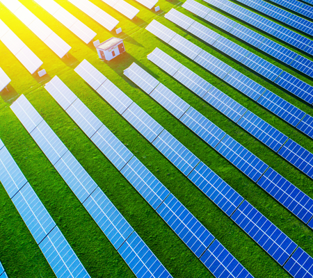 Daytime aerial view of a solar farm lit by bright sunshine