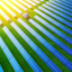 Daytime aerial view of a solar farm lit by bright sunshine