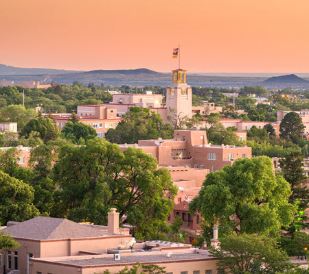 Sunset view of the Santa Fe skyline with mountains in the distance