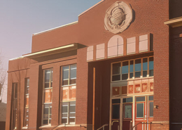 Early morning exterior view of a brick school building in the neoclassical style.