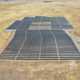 Daytime aerial view of a municipal brownfield solar farm in San Joaquin