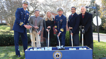 Daytime exterior view of officials at a groundbreaking at the U.S. Coast Guard Academy in New London