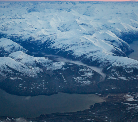 Evening view of sow-capped mountains around Juneau Alaska