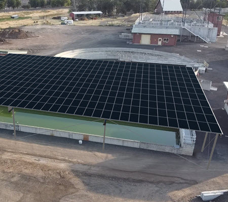 Daytime aerial view of a solar canopy at a water treatment plant in Pendleton