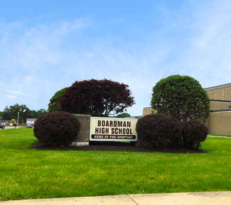 Daytime view of a sign outside Boardman High School reading Home of the Spartans