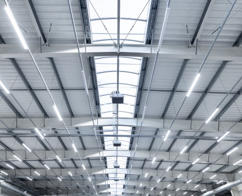LED area lighting shown looking up at the interior of a warehouse
