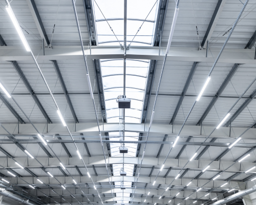LED area lighting shown looking up at the interior of a warehouse