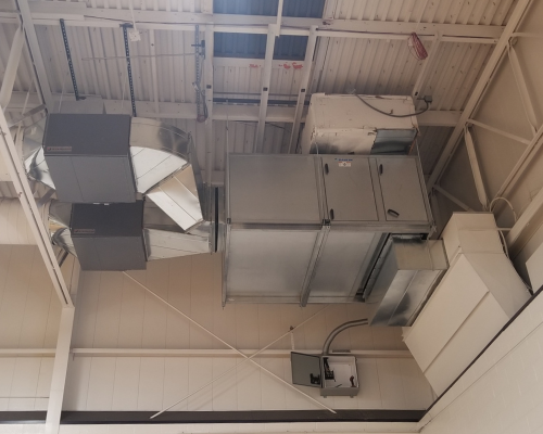 Concept image for the Pennsylvania Guaranteed Energy Savings Act shows an interior view of HVAC equipment mounted near the ceiling of a large building