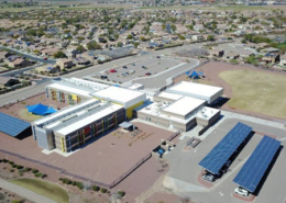 Daytime aerial view of solar car ports at a school building in the Marana Unified School District