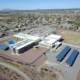 Daytime aerial view of solar car ports at a school building in the Marana Unified School District