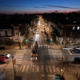 Evening aerial view of municipal LED streetlighting at a residential intersection in Philadelphia
