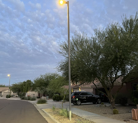 Evening view of a neighborhood lit by municipal LED streetlights