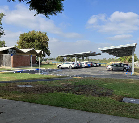 Daytime exterior view of K-12 school solar car ports in Orange Unified School District
