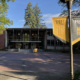 Daytime view of the administration building at Pacific Lutheran University with school banners in the foreground