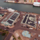 Daytime aerial view of Fresh Island Fish Company buildings with solar panels on the roof